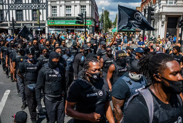 People take part in an Afrikan Emancipation Day reparations march, in Brixton, south London, Saturday, August 1, 2020. A coalition of groups including the Afrikan Emancipation Day Reparations March Committee and Extinction Rebellion gathered for the annual event in South London which aims to highlight the need for reparations and amendments to be made for enslavement endured by generations of black people. (Photo by Guy Bell/Rex Features/Shutterstock)