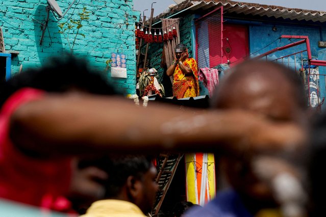 A woman reacts as she watches a devotee's mouth being pierced with a metal skewer, during a procession for the religious festival of Panguni Uthiram, celebrated in honour of Hindu God Murugan, in New Delhi, India, on April 11, 2025. (Photo by Priyanshu Singh/Reuters)