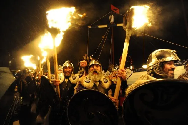 Members of the 2013 'Jarl Squad' take part in the annual Up Helly Aa festival which culminates in the burning of a Viking Galley in Lerwick, Shetland Islands on January 29, 2013. Up Helly Aa celebrates the influence of the Scandinavian Vikings in the Shetland Islands and has employed this theme in the festival since 1870. The event culminates with up to 1,000 'guizers' (men in costume) throwing flaming torches into their Viking longboat. AFP PHOTO / ANDY BUCHANAN        (Photo credit should read Andy Buchanan/AFP/Getty Images)