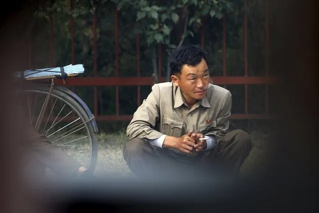 A man smokes a cigarette in downtown Pyongyang, North Korea October 8, 2015. (Photo by Damir Sagolj/Reuters)