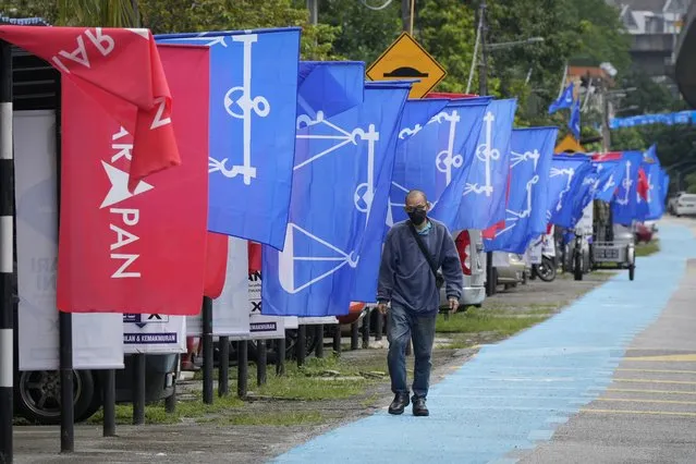 Flags of Malaysia's ruling National Front coalition, or Barisan Nasional (blue) and Pakatan Harapan (Alliance of Hope) coalition (red) are displayed in Kuala Lumpur, Malaysia, Thursday, November 17, 2022. Malaysia's general elections will take place Saturday, over a month after Prime Minister Ismail Sabri Yaakob dissolved Parliament and announced snap elections. The country's longest-serving coalition is seeking to regain its dominance after a shocking loss in 2018, but political reformers are aiming for a second surprise win. (Photo by Vincent Thian/AP Photo)