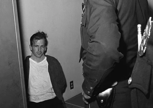 Lee Harvey Oswald sits in police custody shortly after being arrested for the assassination President John F. Kennedy, and the murder of Dallas police officer J. D. Tippit, in Dallas, Texas, on November 22, 1963. (Photo by AP Photo)