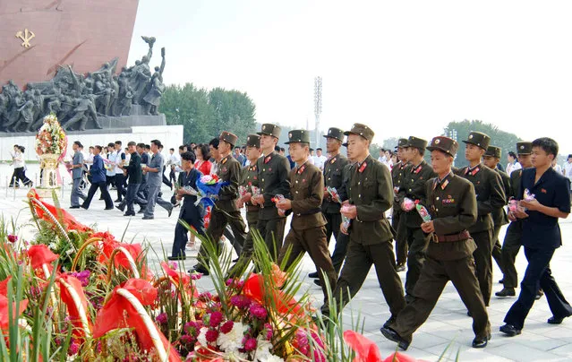Service personnel and civilians lay flowers before the statues of President Kim Il Sung and leader Kim Jong Il on the 68th founding anniversary of the DPRK in this undated photo released by North Korea's Korean Central News Agency (KCNA) September 9, 2016. (Photo by Reuters/KCNA)