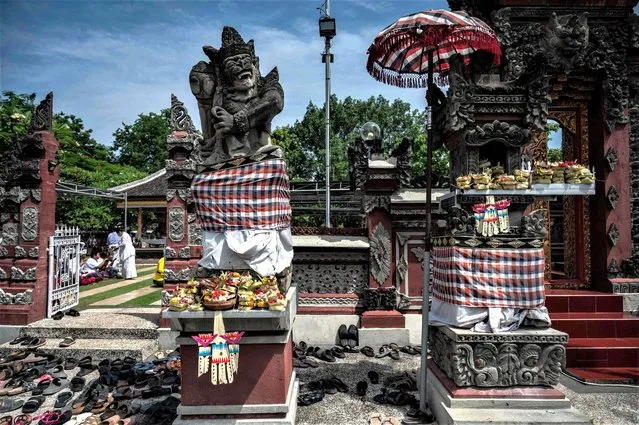 Hindu devotees offer prayers during the Galungan festival at Segara temple in Surabaya on January 4, 2023. (Photo by Juni Kriswanto/AFP Photo)