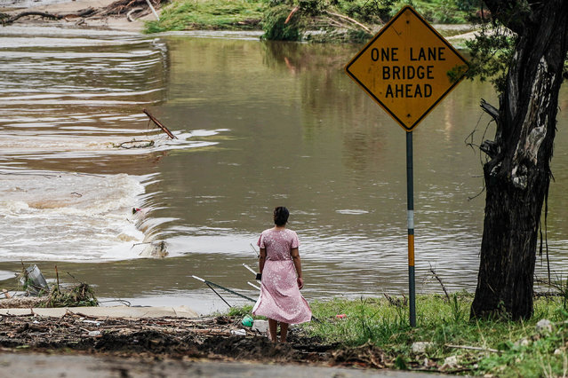 People watch the Guadalupe River flow over a bridge in Kerrville, Texas, USA 05 July 2025. Twenty seven people are confirmed dead and dozens missing after floodwaters swept through a summer camp and nearby homes early 04 July. Search and Rescue teams continue working around the clock following flash flooding on the Guadalupe River in Kerr County. (Photo by Dustin Safranek/EPA)