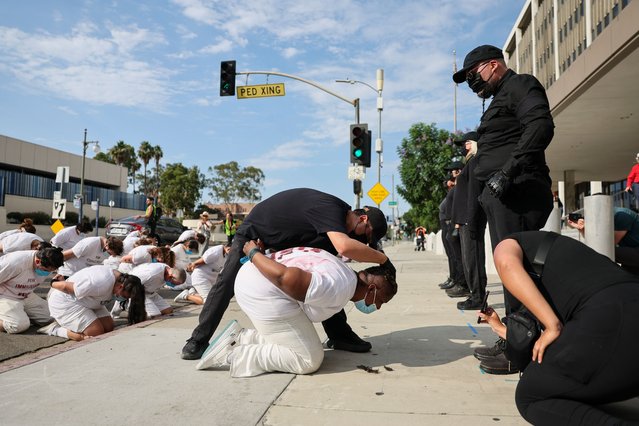 People participate in an performative art piece titled “The Disappeared/Los Desaparecidos” that involves performers acting as law enforcement agents taking and arresting people, during a national day of nonviolent action against the Trump administration and deportations, outside of the Edward R. Roybal Federal Building in Los Angeles, California, USA, 17 July 2025. This event is part of a national day of nonviolent protest with topics that include: The John Lewis Voting Rights Advancement Act, The Freedom to Vote Act, The Native American Voting Rights Act, The DC Admission Act. (Photo by Allison Dinner/EPA)