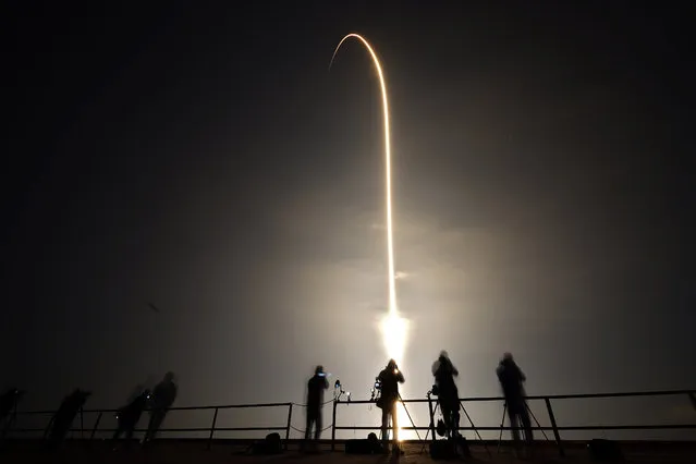 A SpaceX Falcon 9 rocket lifts off in this time exposure photograph from Launch Pad 39-A Thursday, March 2, 2023, at the Kennedy Space Center in Cape Canaveral, Fla. Four astronauts are beginning a mission to the International Space Station. (Photo by Chris O'Meara/AP Photo)