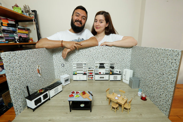 Videographer Anil Aydin and his wife, miniature food cook Burcu Celenoglu Aydin, pose with their mini kitchen in Istanbul, Turkey on April 11, 2018. (Photo by Murad Sezer/Reuters)