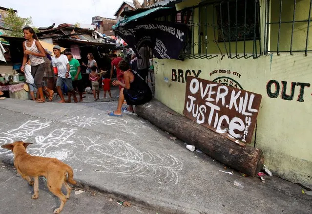 A sign reading “Overkill Justice for Eric” is pictured at the entrance of a street where Eric Quintinita Sison was killed in Pasay city, Metro Manila in the Philippines August 29, 2016. (Photo by Erik De Castro/Reuters)