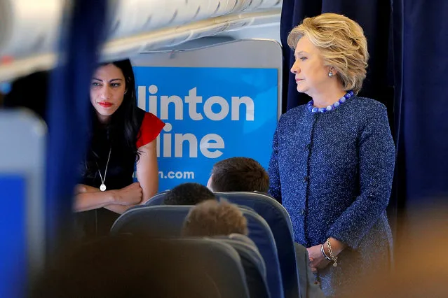 U.S. Democratic presidential nominee Hillary Clinton talks to staff members, including aide Huma Abedin (L), onboard her campaign plane in White Plains, New York, U.S. October 28, 2016. (Photo by Brian Snyder/Reuters)
