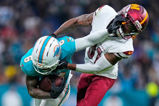Washington Commanders cornerback Jonathan Jones, right, tackles Miami Dolphins wide receiver Malik Washington during an NFL game in Madrid on Sunday, November 16, 2025. (Photo by Manu Fernandez/AP Photo)