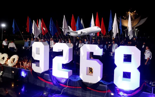 People stand behind the Russian MetroJet crash flight number and a plane model during a ceremony to mark the first anniversary of the plane crash, in the Red Sea resort of Sharm el-Sheikh, Egypt October 30, 2016. (Photo by Amr Abdallah Dalsh/Reuters)
