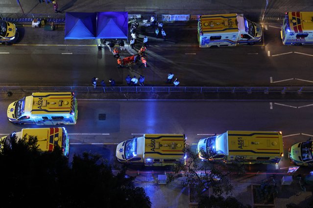 A person receives medical attention as a fire burns bamboo scaffolding across multiple buildings at Wang Fuk Court housing estate in Tai Po, Hong Kong, China, on November 26, 2025. (Photo by Tyrone Siu/Reuters)