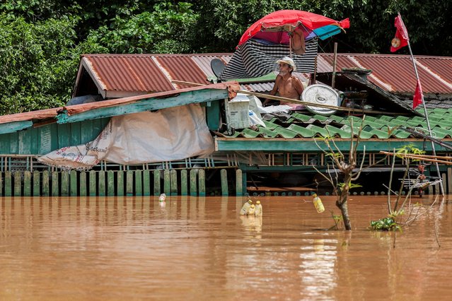 La-iat Taengsong, 70, rests on the roof of his house, which is submerged on the banks of flooded Noi river, affected by heavy rainfall and overflowing rivers, with Ayutthaya as one of the worst-hit areas, at Sena district, in Ayutthaya province, Thailand, on October 8, 2025. (Photo by Chalinee Thirasupa/Reuters)
