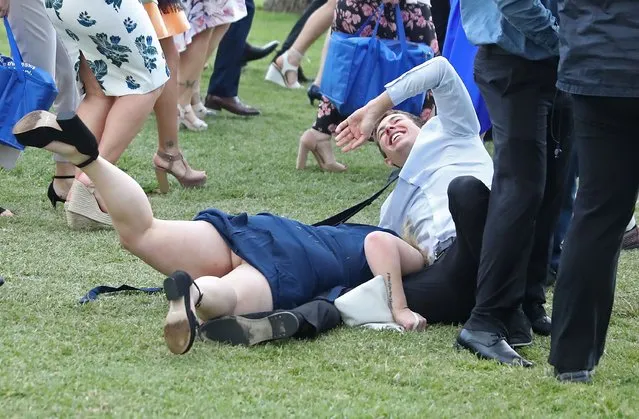 Racegoers trip over each other following 2016 Melbourne Cup Day at Flemington Racecourse on November 1, 2016 in Melbourne, Australia. (Photo by Scott Barbour/Getty Images)
