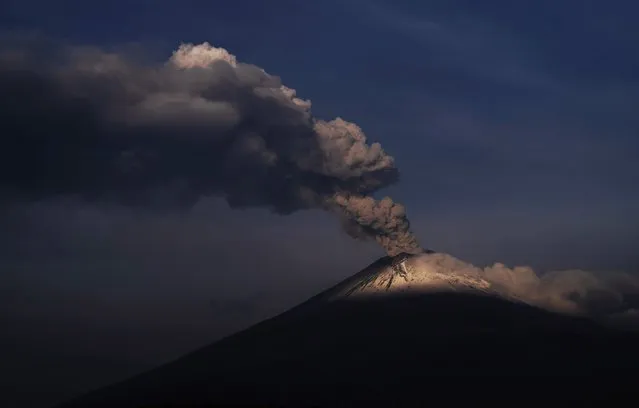 The Popocatepetl volcano spews ash and steam, seen from Santiago Xalitzintla, Mexico, Wednesday, May 24, 2023. (Photo by Marco Ugarte/AP Photo)