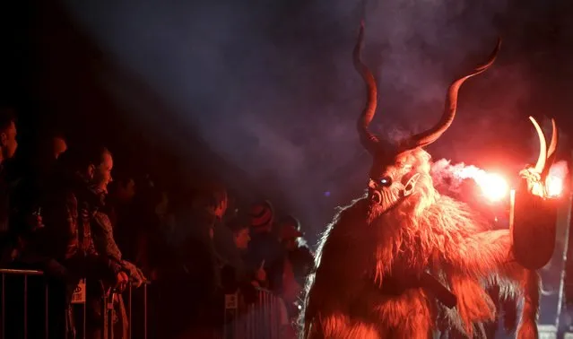 A man dressed as a devil performs during a Krampus show in the southern Bohemian town of Kaplice, December 12, 2015. (Photo by David W. Cerny/Reuters)