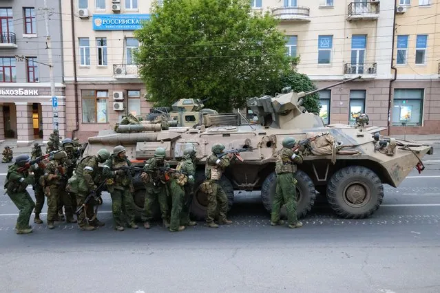 PMC Wagner fighters stand outside the Southern Military District headquarters in Rostov-On-Don, Russia on June 24, 2023. (Photo by Erik Romanenko/TASS)