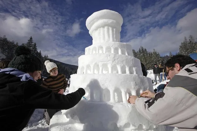 Participants make a snow sculpture for a competition during a snow festival called “King Matjaz's Castles” in Crna na Koroskem, Slovenia January 31, 2015. Some 50 teams from Slovenia and Croatia are taking part in the competition as part of the two-day festival. (Photo by Srdjan Zivulovic/Reuters)