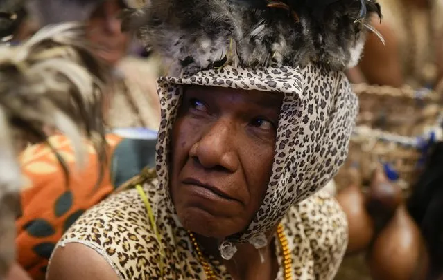 A Leco Amazon Indigenous person attends a ceremony where agreements are signed that aim to conserve biodiversity in the protected areas of Madidi, where the Leco live, as well as the Indigenous areas of Pion Lajas and Apolobamba, at the Vice President office in La Paz, Bolivia, Monday, May 9, 2022. The Indigenous live from hunting and fishing along the Madidi river and say their way of life is being threatened by gold mining. (Photo by Juan Karita/AP Photo)