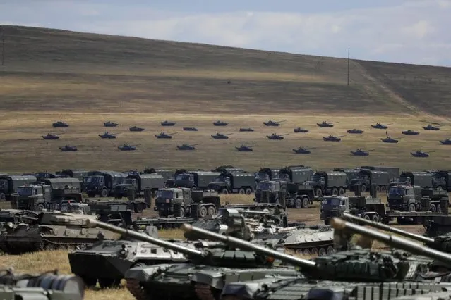 Tanks and other armored vehicles on the training ground “Tsugol”, about 250 kilometers (156 miles ) south-east of the city of Chita during the military exercises Vostok 2018 in Eastern Siberia, Russia, Thursday, Sept. 13, 2018. The weeklong Vostok (East) 2018 maneuvers launched Tuesday span vast expanses of Siberia and the Far East, the Arctic and the Pacific Oceans. They involve nearly 300,000 Russian troops along with 1,000 Russian aircraft and 36,000 tanks and other combat vehicles. (Photo by Sergei Grits/AP Photo)