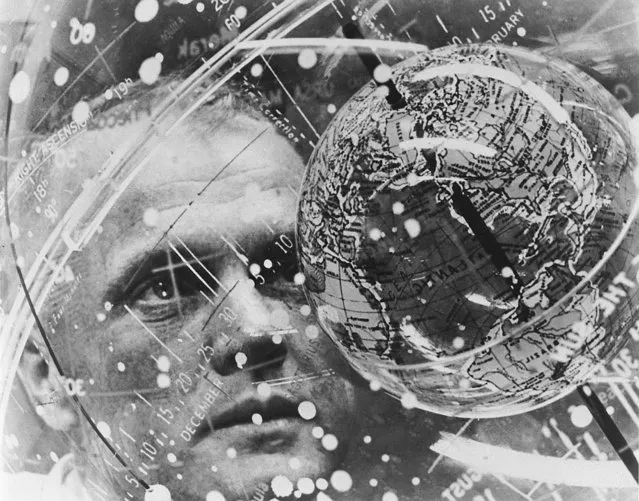 In this February 1962 photo made available by NASA, astronaut John Glenn looks into a Celestial Training Device globe at the Aeromedical Laboratory at Cape Canaveral, Fla. (Photo by NASA via AP Photo)