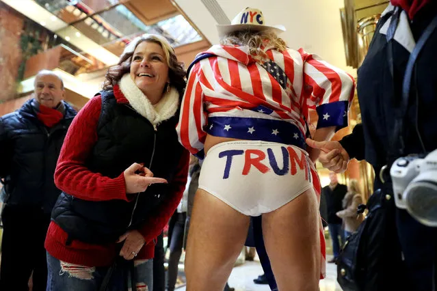 Marty Gonzales, from San Diego, CA, points at the underwear of Robert Burck, known as the original “Naked Cowboy”, as they stand in the lobby of Trump Tower in New York, U.S., December 10, 2016. (Photo by Mark Kauzlarich/Reuters)