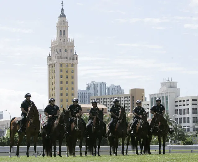 In this October 21, 2008 file photo, mounted city of Miami police line up in front of the famed Freedom Tower as they wait for a rally with then Democratic presidential candidate, Sen. Barack Obama, D-Ill., at Bicentennial Park in Miami. A preservation group is inviting the public to vote on twenty sites across the country, including the Freedom Tower, that showcase the nation's diversity and the fight for equality as part of a $2 million historic preservation campaign.  (Photo by Wilfredo Lee/AP Photo)
