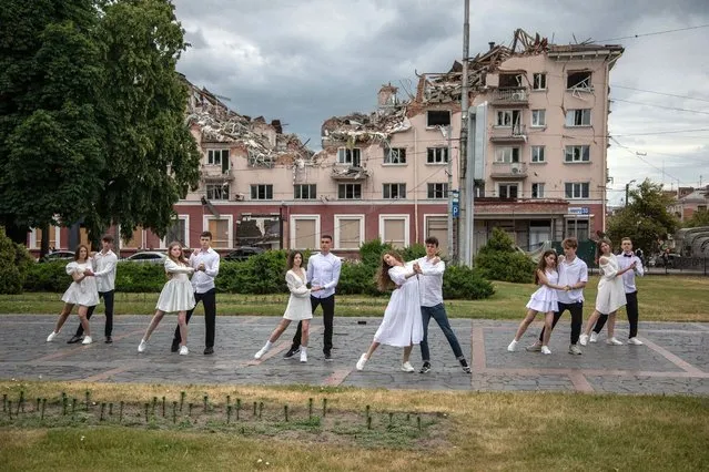 High school graduates from School One from Chernihiv are dancing to the song “Dream” (Mria) before the destroyed Hotel Ukraine on June 23, 2022. Only eleven of the 28 students remained in the city. “I learned that you can live under rocket fire”, says student Anastasia Fyl (17). On 24 February 2022, during the 2022 Russian invasion of Ukraine, the city was under siege by the Russian Armed Forces. On 5 April 2022 Governor of Chernihiv Oblast stated that the Russian military has left Chernihiv Oblast. (Photo by Michal Burza/ZUMA Press Wire/Rex Features/Shutterstock)