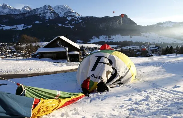 Participants deflate their balloon after a flight during the 38th International Hot Air Balloon Week in Chateau-d'Oex, Switzerland January 23, 2016. (Photo by Denis Balibouse/Reuters)