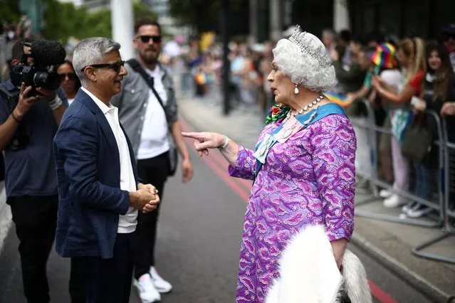 London Mayor Sadiq Khan talks to a person dressed as a queen, at the 2022 Pride Parade in London, Britain on July 2, 2022. (Photo by Henry Nicholls/Reuters)