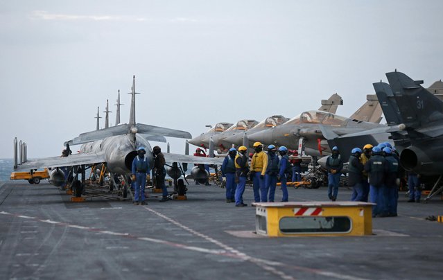 Rafale and Super Etendards fighter jets are parked following a mission aboard France's Charles de Gaulle aircraft carrier sailing in the Gulf, January 28, 2016. (Photo by Philippe Wojazer/Reuters)