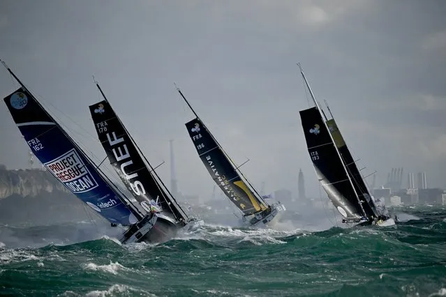 Class 40 monohulls Project Rescue Ocean (L), SNEF, and Alternative Sailing  sail at the start of the Jacques Vabre pair sailing race, from Le Havre to the French overseas island of La Martinique, in Le Havre on October 29, 2023. Ths start of the Imoca 40 ships in the Transat Jacques-Vabre was delayed due to heavy weather, but the departure of the 55 boats of other classes Ultim, Ocean Fifty and Class40 has been maintained. (Photo by Loic Venance/AFP Photo)