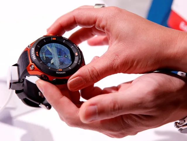 Attendees look over a Casio WSD-F20 Pro Trek Smart watch with built-in GPS, expected to be available in April according to a representative, during the 2017 CES in Las Vegas, Nevada January 5, 2017. (Photo by Steve Marcus/Reuters)