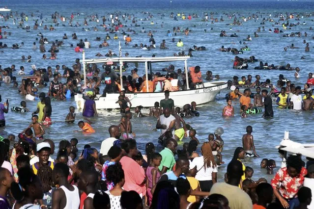 Holiday makers enjoys a day on the beach along the Coastal region at the Jomo Kenyatta Public beach in Mombasa County, Kenya, Monday December 25, 2023. (Photo by Gideon Maundu/AP Photo)