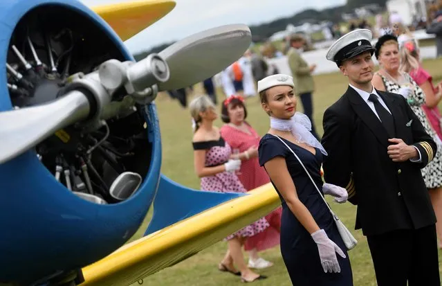 Motoring enthusiasts attend the Goodwood Revival, a three-day historic car racing festival in Goodwood, Chichester, southern Britain, September 17, 2021. (Photo by Toby Melville/Reuters)