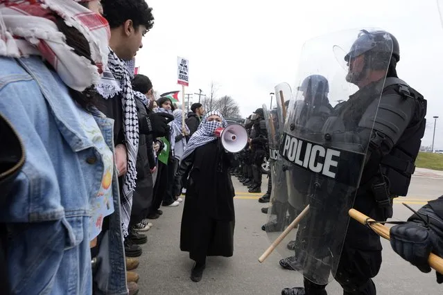 Pro-Palestinian demonstrators march against police during a visit by President Joe Biden in Warren, Mich., Thursday, February 1, 2024. (Photo by Paul Sancya/AP Photo)