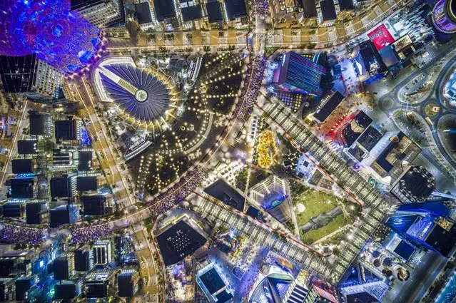 An aerial view shows a giant landart fresco, bottom right, by French-Swiss artist Saype, painted for the 11th step of his worldwide “Beyond Walls” project at the Expo 2020 World Exhibition in Dubai, United Arab Emirates, Thursday, October 28 2021. (Photo by Valentin Flauraud/AP Photo)