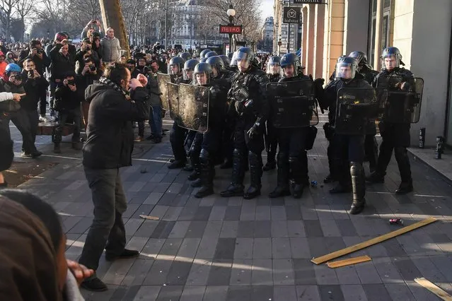 Protestors clash with police during demonstration over the alleged rape of a 22-year-old man identified only as Theo while being arrested by French police, at the Republique square in Paris, France on February 18, 2017. The unrest which started in several Paris suburbs, quickly spread to Lille, Marseille and other French cities, carrying echoes of riots that rocked the country in 2005 over the deaths of Bouna Traore, 15, and Zyed Benna, 17 – electrocuted in a power substation after being chased by police in Clichy-sous-Bois. (Photo by Splash News and Pictures)
