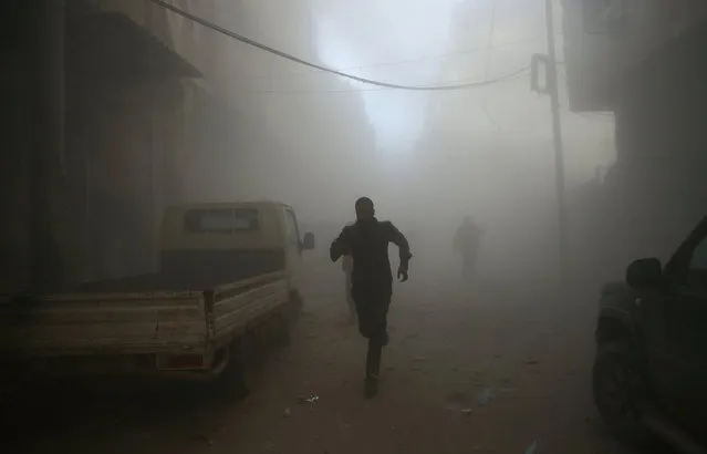 Men run at a site hit by airstrikes in the rebel held besieged Douma neighbourhood of Damascus, Syria February 19, 2017. (Photo by Bassam Khabieh/Reuters)