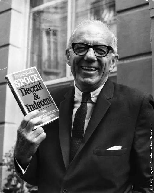 Dr Benjamin Spock  noted for his ideas on child-rearing, on a visit to Britain, holds up a copy of his book, Decent & Indecent