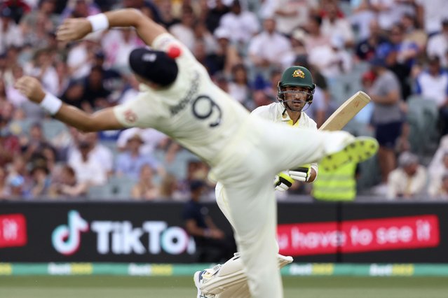 Australia's Mitchell Starc, right, hits a ball past England's James Anderson during the second day of their Ashes cricket test match in Adelaide, Australia, Friday, December 17, 2021. (Photo by James Elsby/AP Photo)