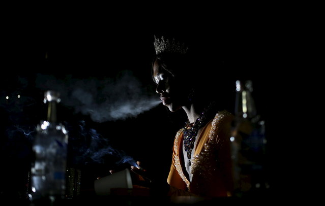 A contestant takes a smoke break during the Miss Gay Jozi pageant in Johannesburg, May 23, 2015. (Photo by Siphiwe Sibeko/Reuters)
