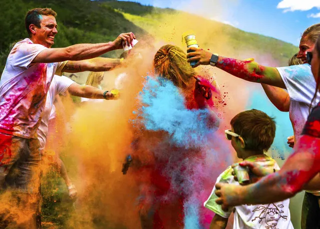 Red Sandstone Elementary School Principal Marcie Laidman gets coated in color during the first annual Color Run on the last day of school Wednesday, June 12, in Vail, Colo. The students held a penny war, raising money all week. The most money raised allowed the students to douse their teachers. (Photo by Chris Dillmann/Vail Daily via AP Photo)