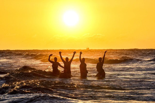 Members of Brighton Swimming Club brave the early morning temperature to take a dip in the sea east of the pier on January 5, 2022. The club, founded in 1860, is the oldest in England. (Photo by Simon Dack/Alamy Live News)