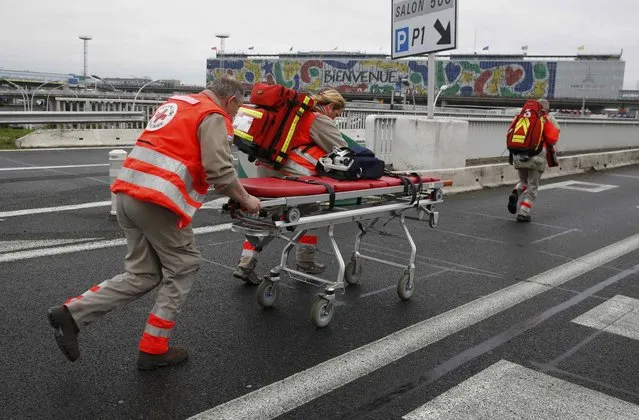 A medical gurney is wheeled into Orly airport southern terminal after a shooting incident near Paris, France March 18, 2016. (Photo by Christian Hartmann/Reuters)