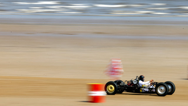 A motoring enthusiast takes part in the “Race The Waves” classic car and motorcycle meet at the beach in Bridlington, Britain, on May 12, 2024. (Photo by Lee Smith/Reuters)