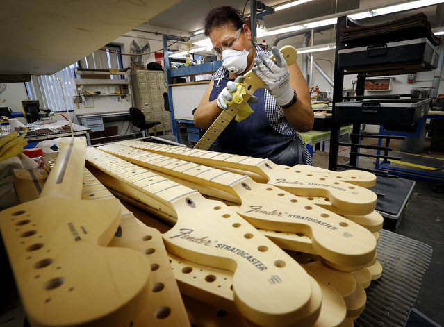 Fender Stratocaster necks are prepared for assembly at the Fender factory in Corona, Calif. on Tuesday, October 15, 2013. (Photo by Matt York/AP Photo)