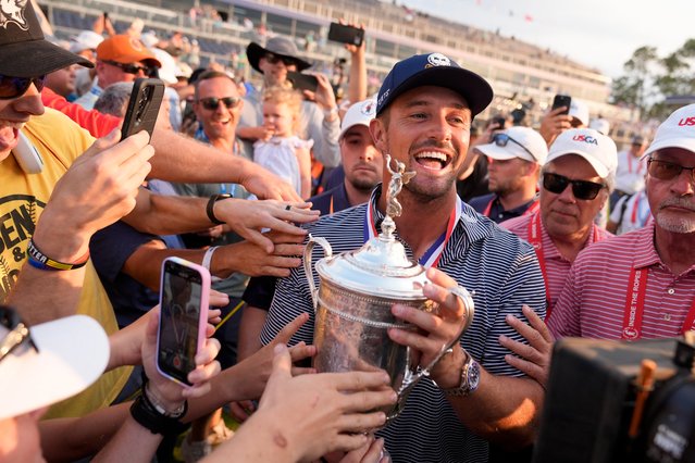 Bryson DeChambeau celebrates with fans and the trophy after winning the U.S. Open golf tournament Sunday, June 16, 2024, in Pinehurst, N.C. (Photo by Frank Franklin II/AP Photo)
