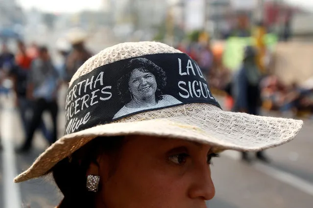 A demonstrator wears a hat with a picture of late environmental and indigenous rights activist Berta Caceres during a protest to demand justice over her murder of in Tegucigalpa, Honduras, May 9, 2016. (Photo by Jorge Cabrera/Reuters)